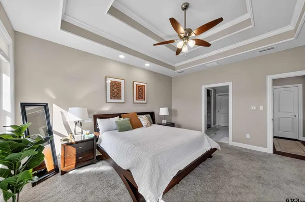 a bedroom with a bed dresser and wooden floor