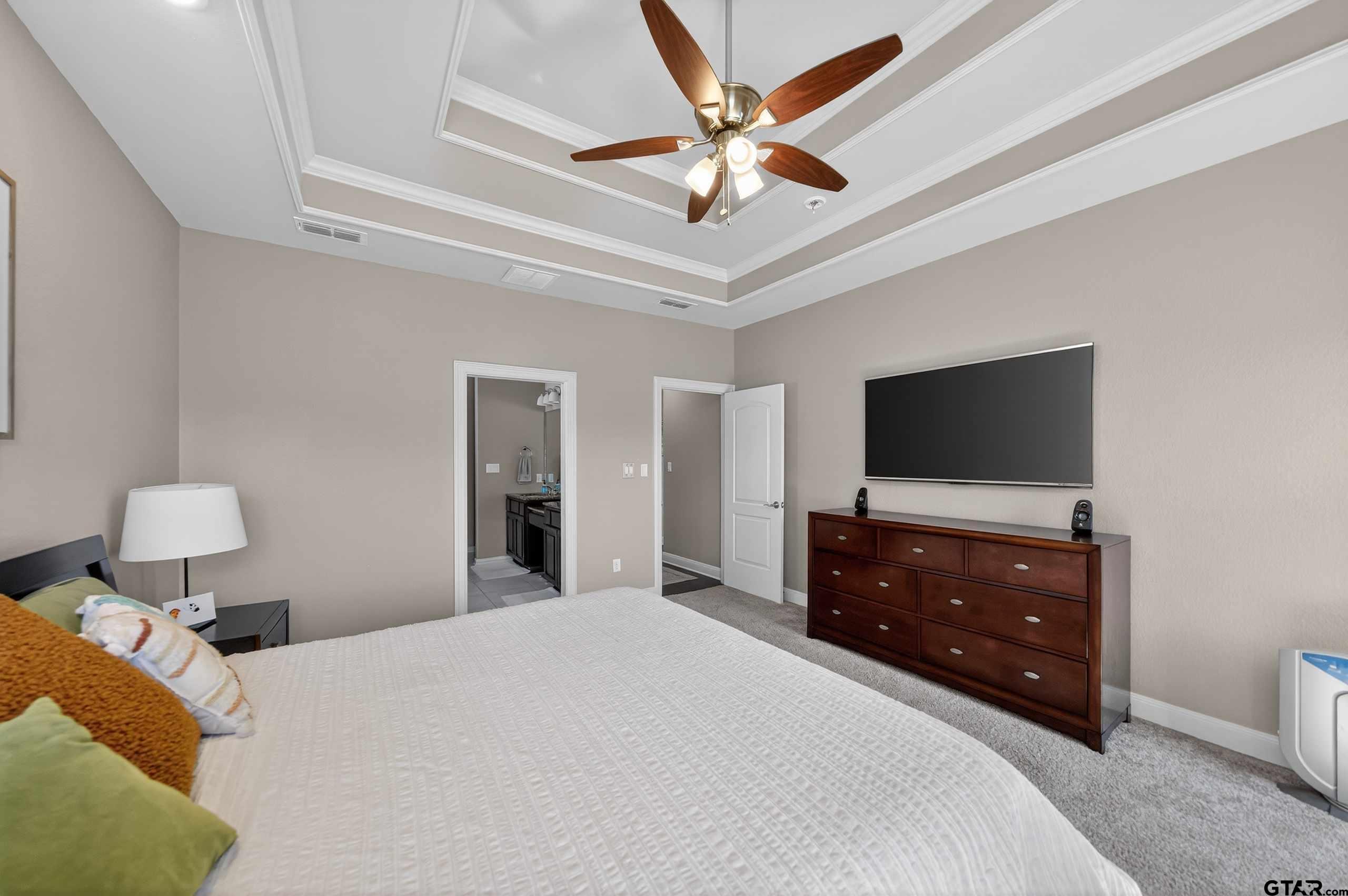 2202 Rana Park Flint, TX 75762 - Photo 29 of 47 a bedroom with a bed and a flat tv screen on dresser