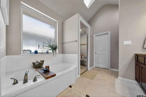a living room with furniture kitchen view and a large window