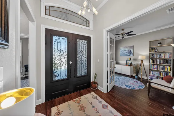 a living room with furniture kitchen view and a chandelier