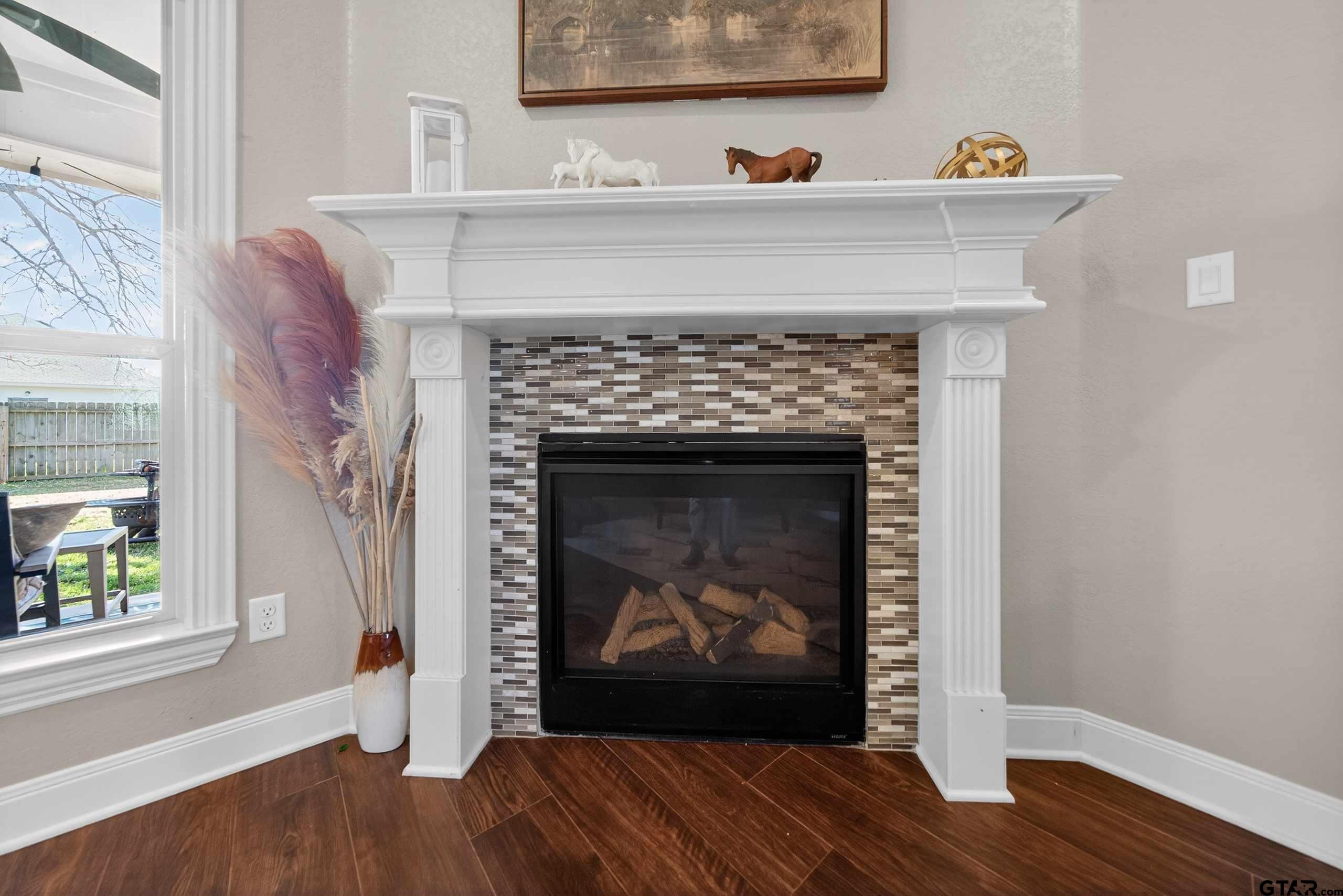 2202 Rana Park Flint, TX 75762 - Photo 40 of 47 a living room with a fireplace and a wooden floor