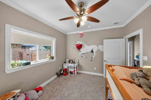 a living room with baby bed furniture and a chandelier