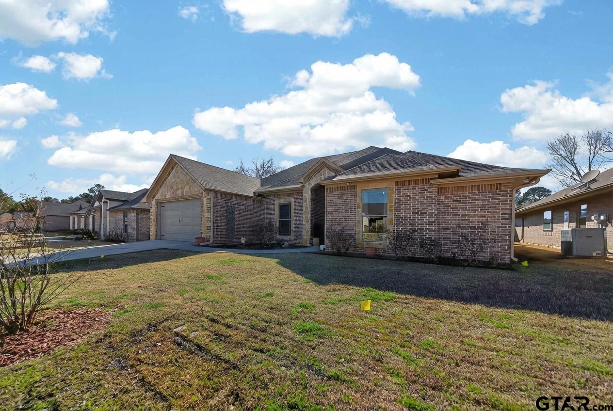 2202 Rana Park Flint, TX 75762 - Photo 9 of 47 a view of a house with a yard and garage