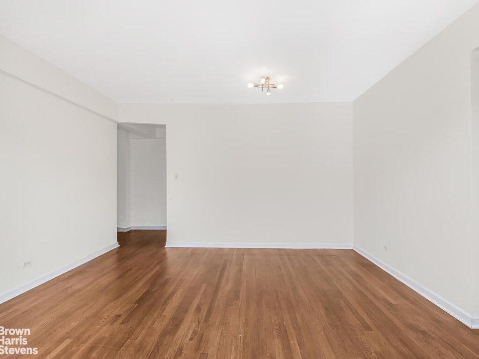 645 West 239th Street, Unit 6C Bronx, NY 10463 - Photo 4 of 18 a view of an empty room with wooden floor