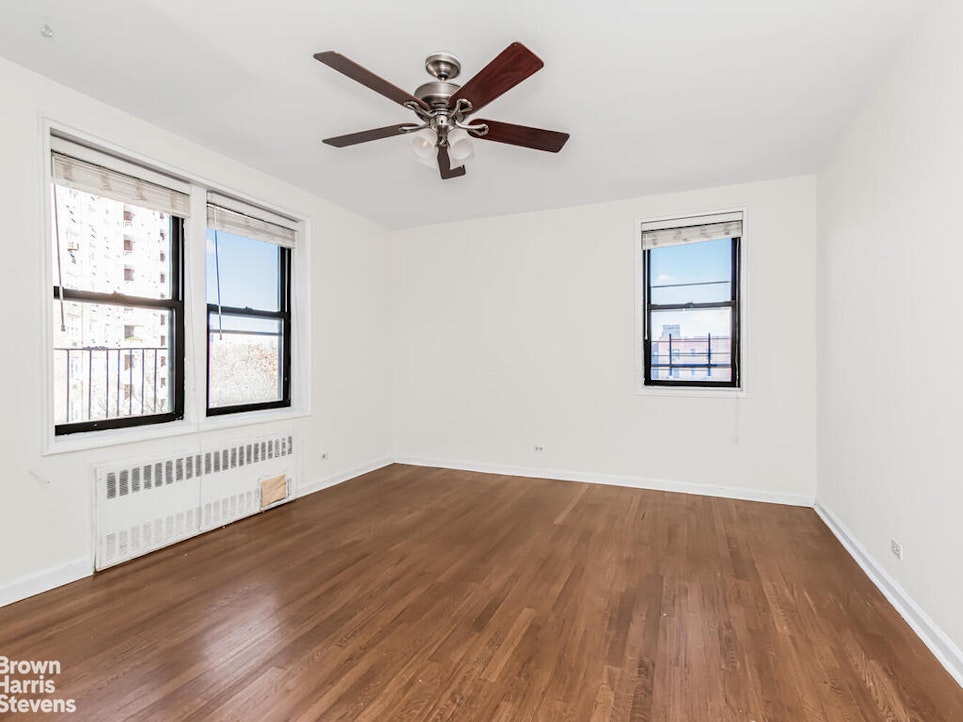 645 West 239th Street, Unit 6C Bronx, NY 10463 - Photo 8 of 18 a view of an empty room with wooden floor and a window