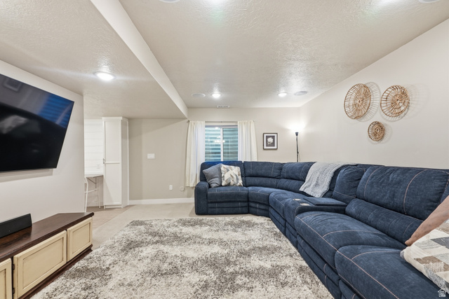3244 West 1670th Street North Provo, UT 84601 - Photo 42 of 56 Recessed lighting illuminates the carpeted living area with light-colored walls