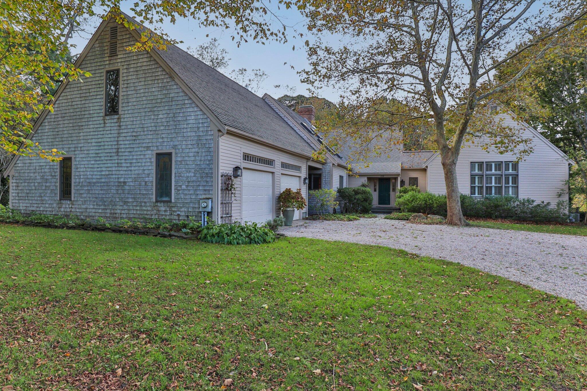 a front view of house with yard and trees