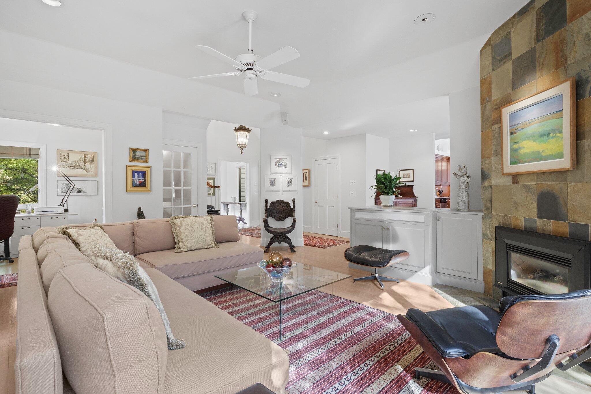 135 Locust Road Eastham, MA 02642 - Photo 8 of 88 a living room with furniture a fireplace and a large window
