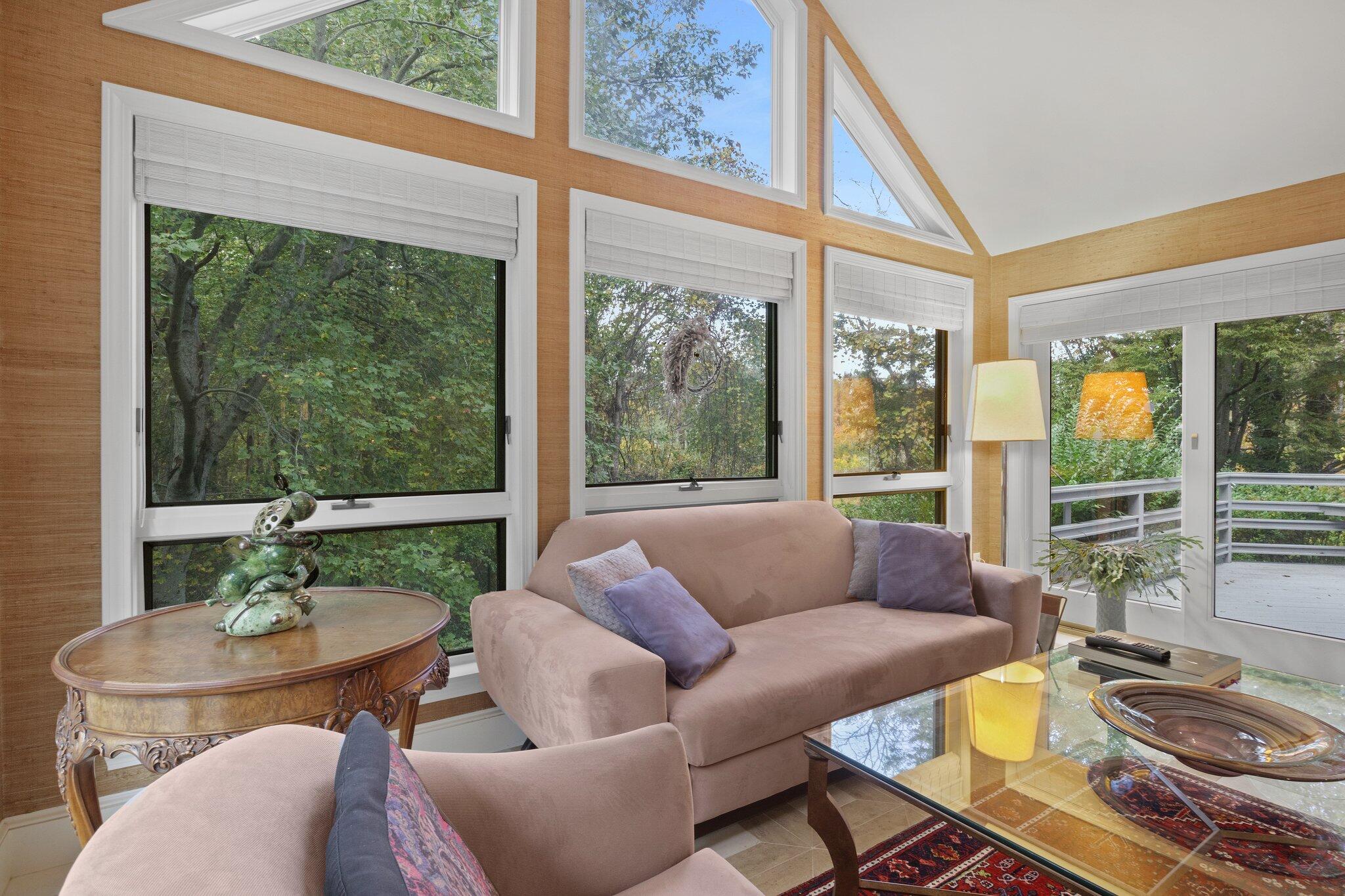 135 Locust Road Eastham, MA 02642 - Photo 16 of 88 a living room with furniture and a floor to ceiling window