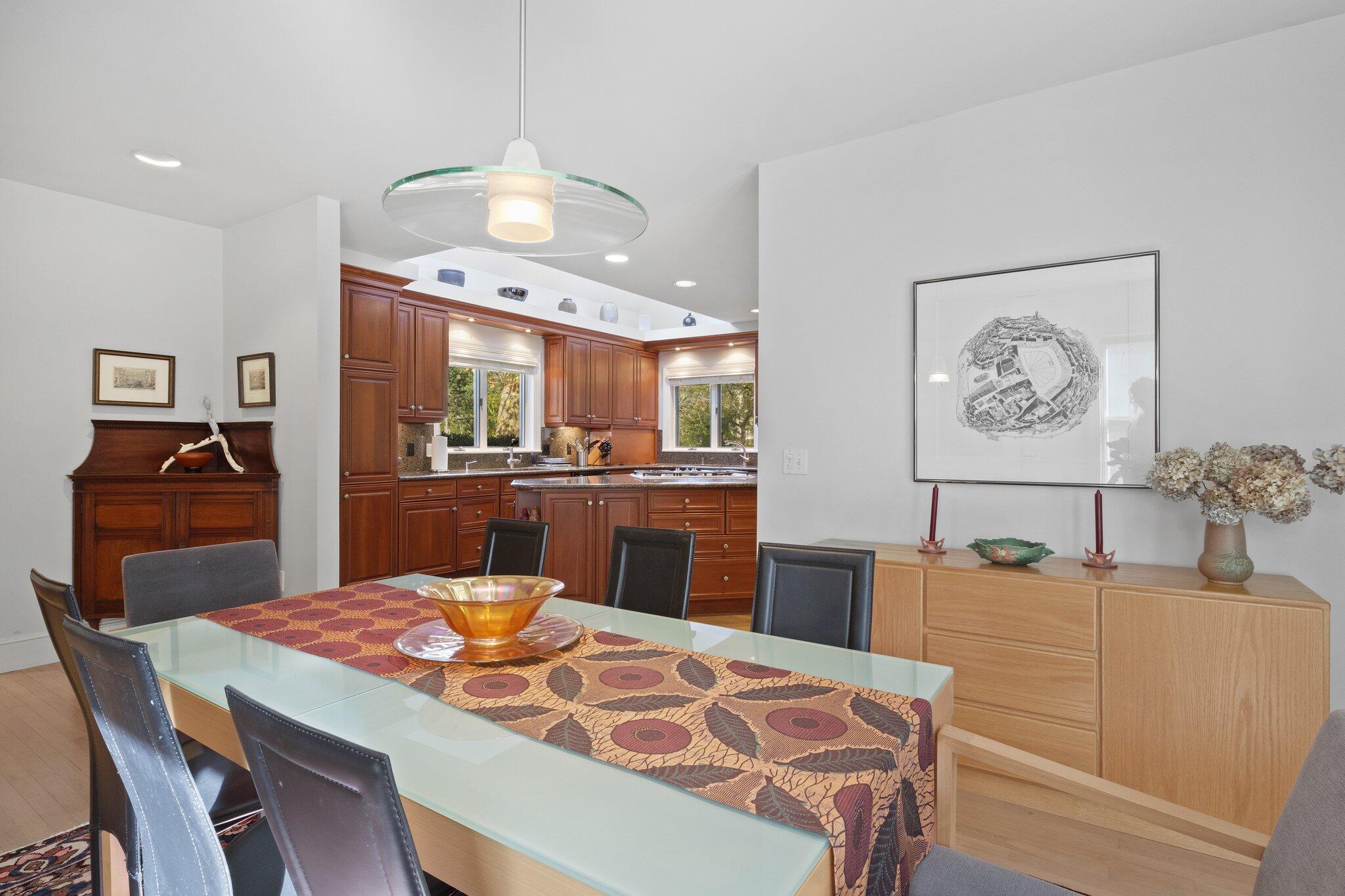 135 Locust Road Eastham, MA 02642 - Photo 21 of 88 a kitchen with stainless steel appliances kitchen island granite countertop a table chairs and a refrigerator