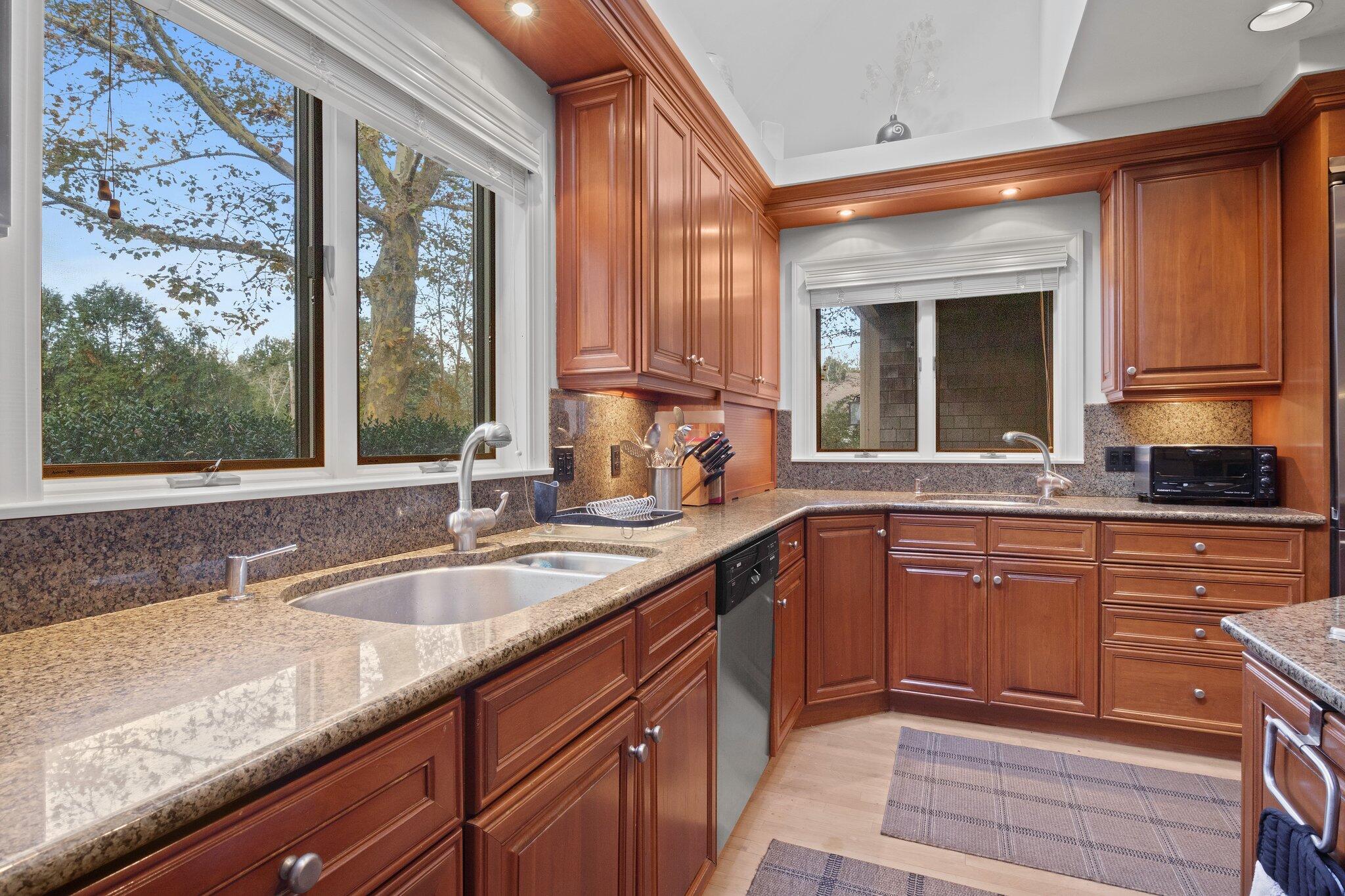 135 Locust Road Eastham, MA 02642 - Photo 26 of 88 a kitchen with granite countertop a sink and wooden cabinets