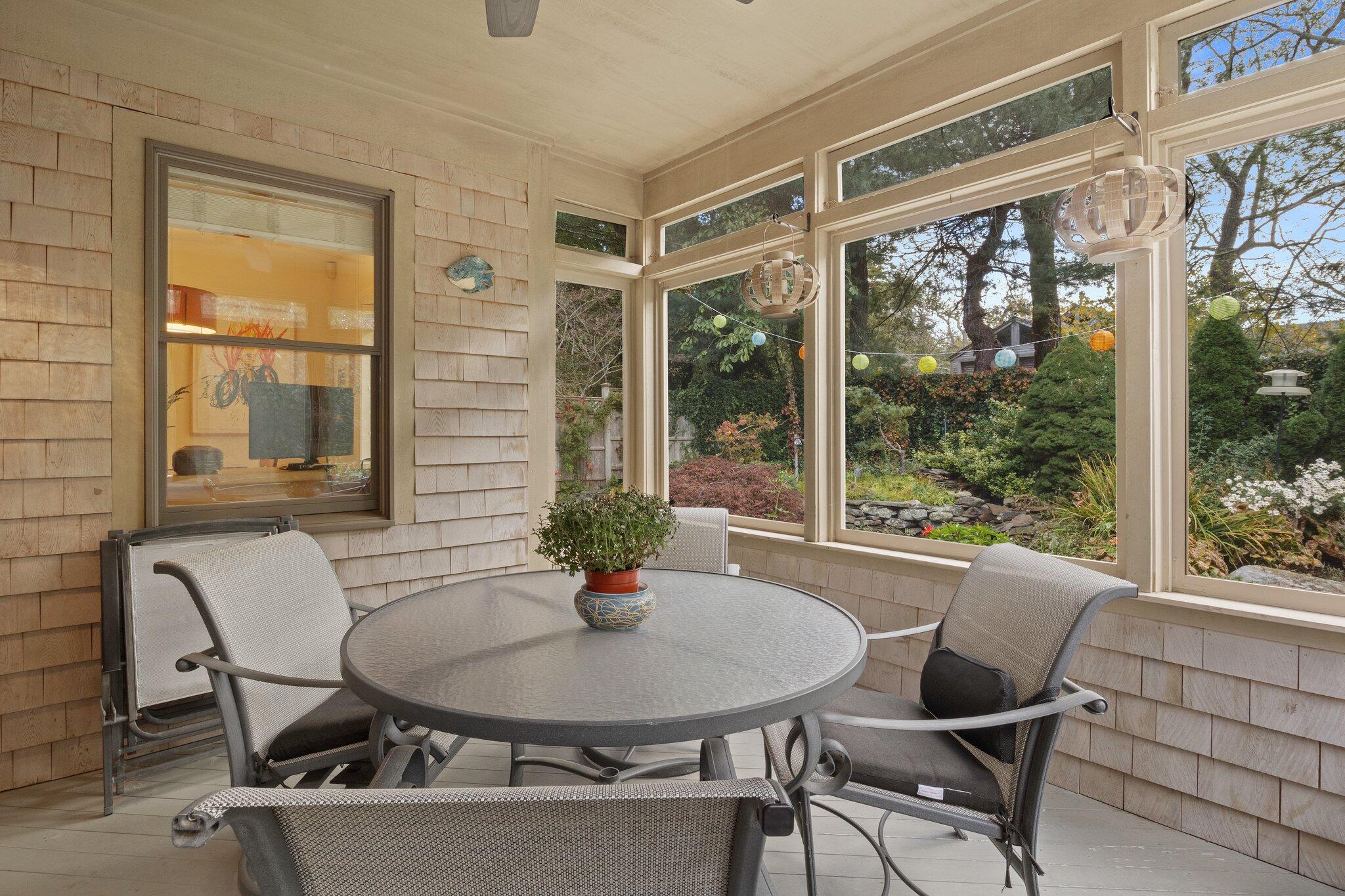 135 Locust Road Eastham, MA 02642 - Photo 31 of 88 a view of a dining room with furniture window and outside view