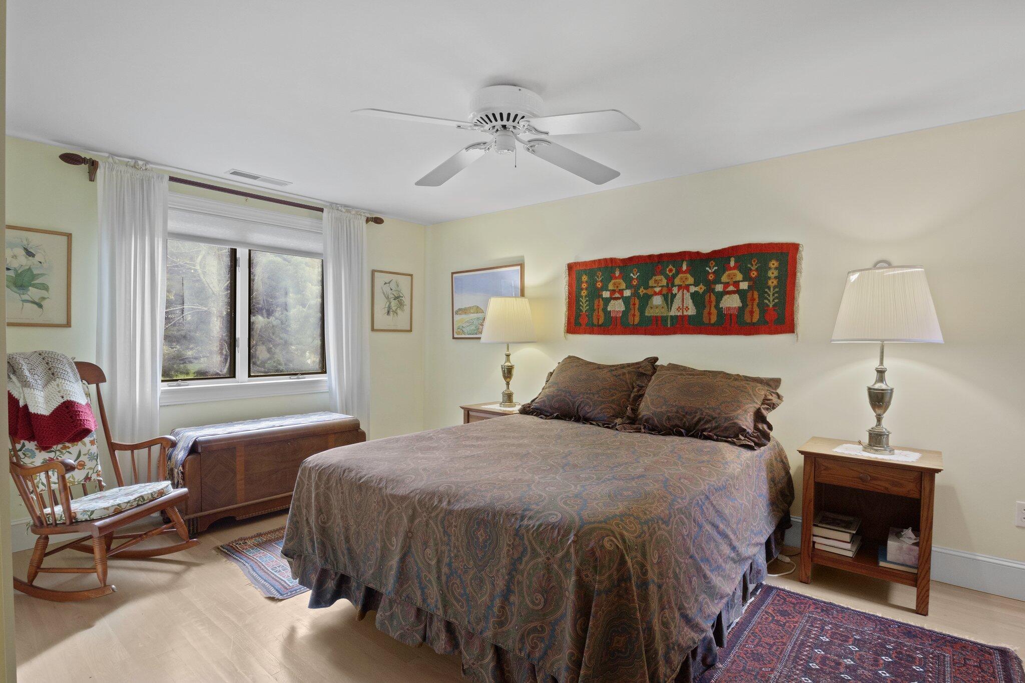 135 Locust Road Eastham, MA 02642 - Photo 52 of 88 a bedroom with a bed and a chandelier