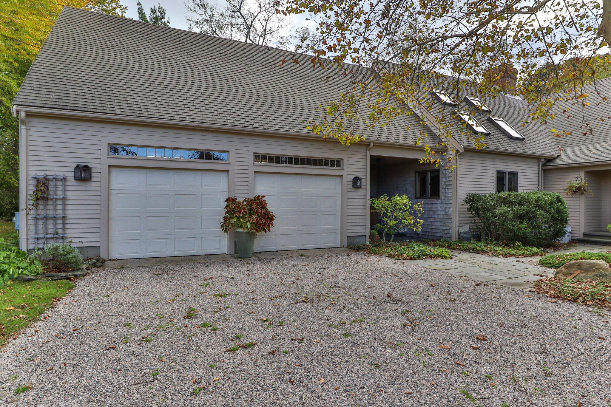 135 Locust Road Eastham, MA 02642 - Photo 3 of 88 a front view of a house with a yard and garage