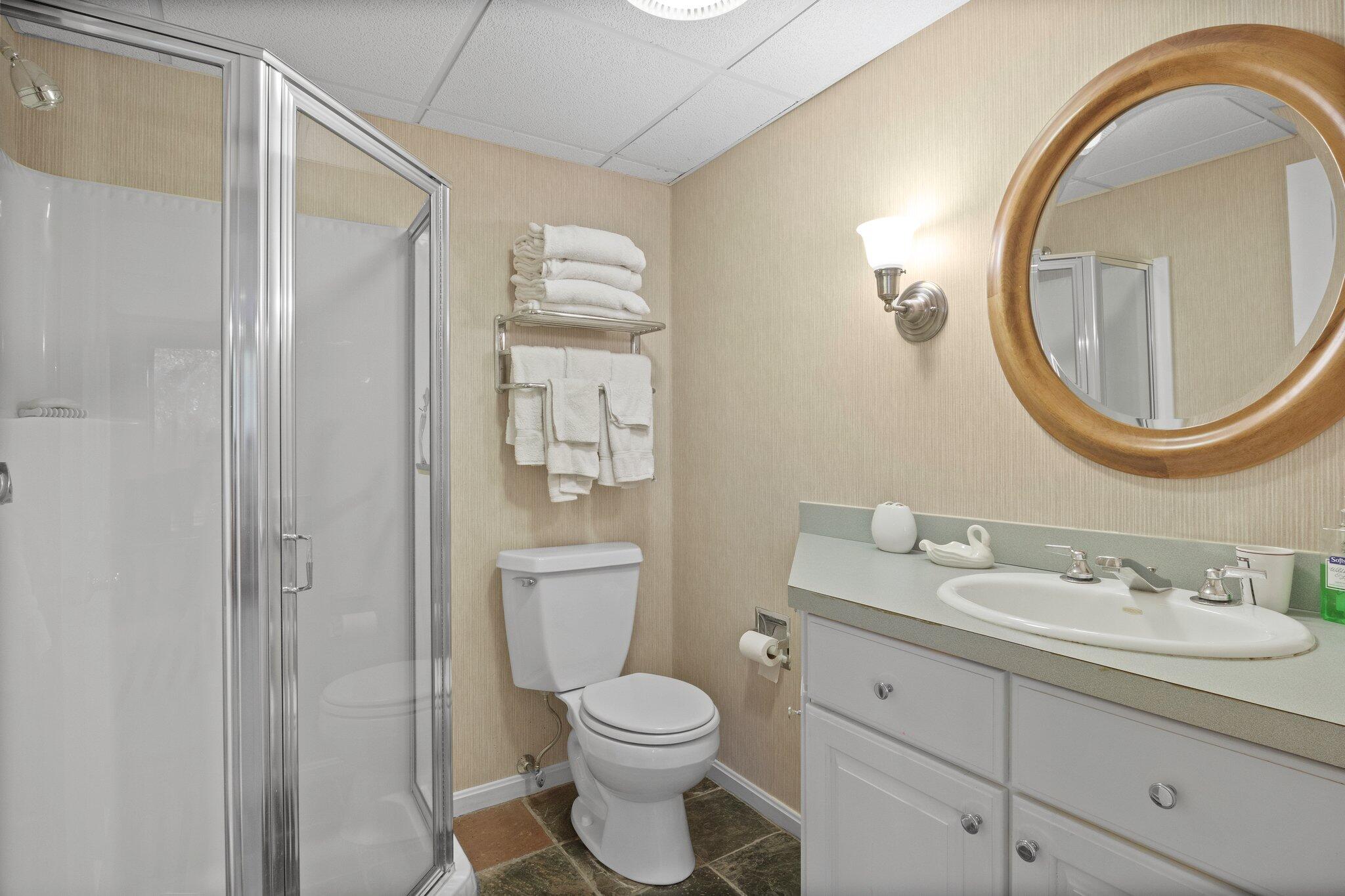 135 Locust Road Eastham, MA 02642 - Photo 60 of 88 a bathroom with a toilet a sink a mirror and vanity