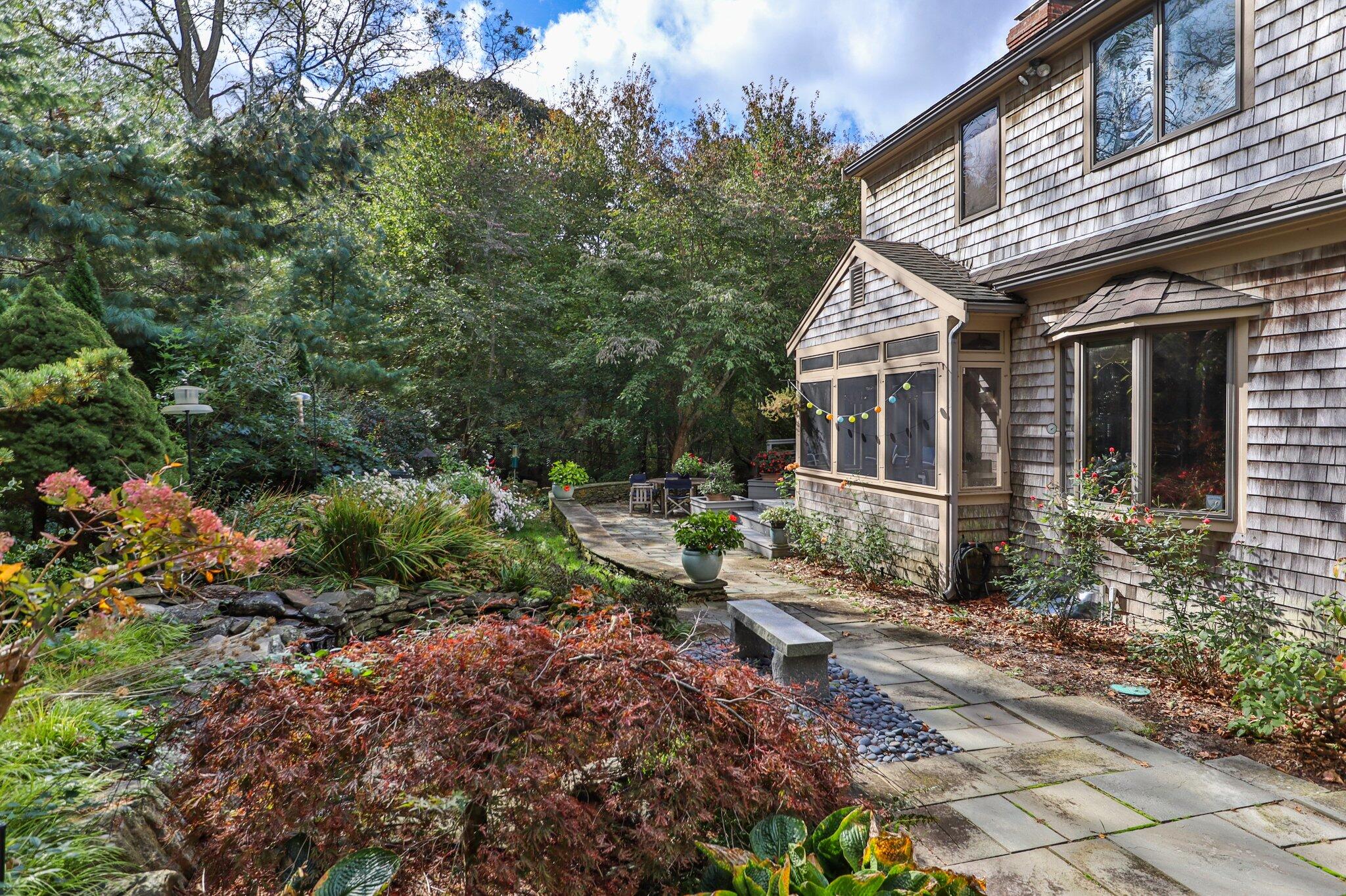 135 Locust Road Eastham, MA 02642 - Photo 73 of 88 a view of a house with backyard sitting area and garden