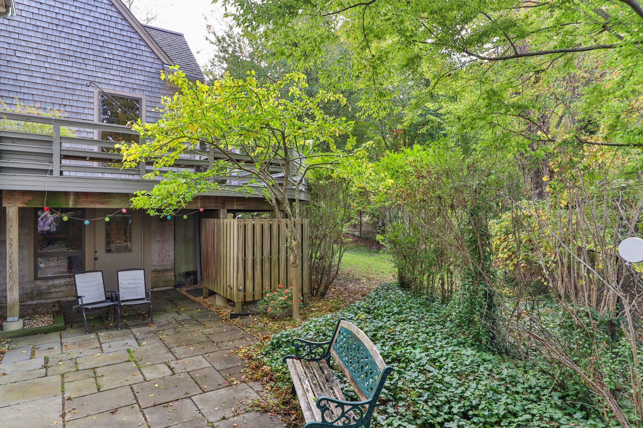135 Locust Road Eastham, MA 02642 - Photo 85 of 88 a backyard of a house with lots of green space and outdoor seating