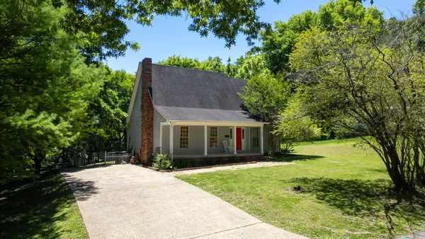 a front view of house with yard and green space