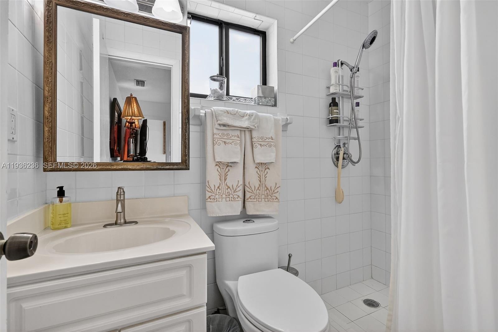 17841 Northwest 84th Court Hialeah, FL 33015 - Photo 14 of 76 a bathroom with a toilet sink and mirror