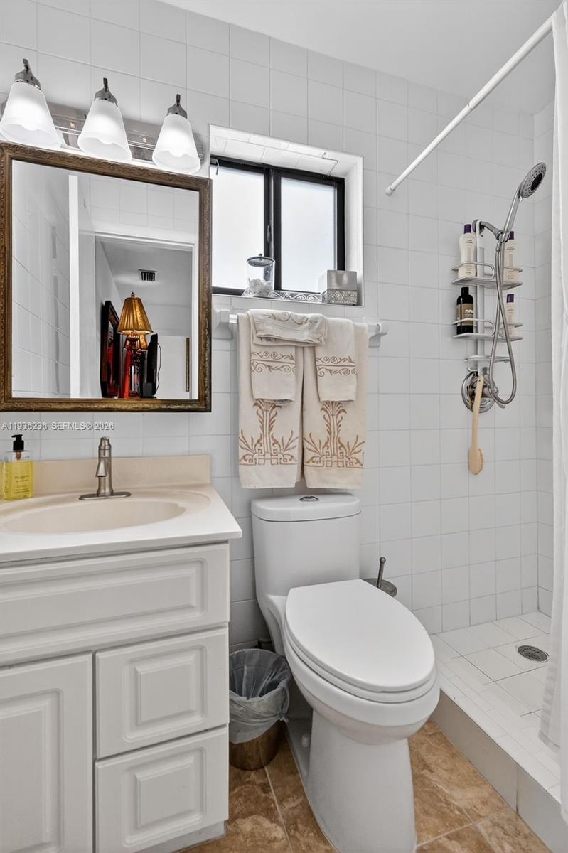 17841 Northwest 84th Court Hialeah, FL 33015 - Photo 15 of 76 a bathroom with a toilet a sink and mirror