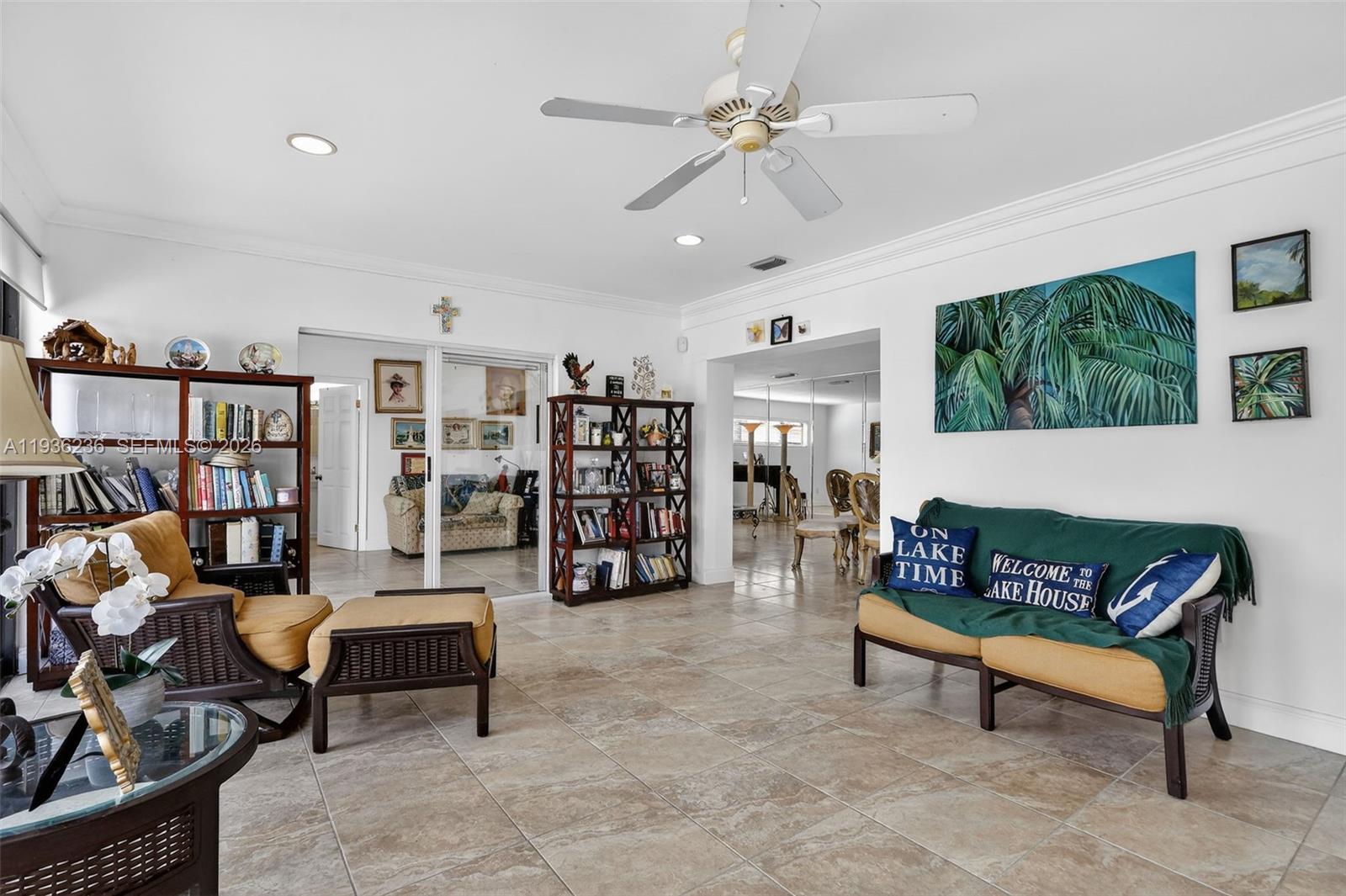 17841 Northwest 84th Court Hialeah, FL 33015 - Photo 22 of 76 a living room with furniture a rug and a bookshelf