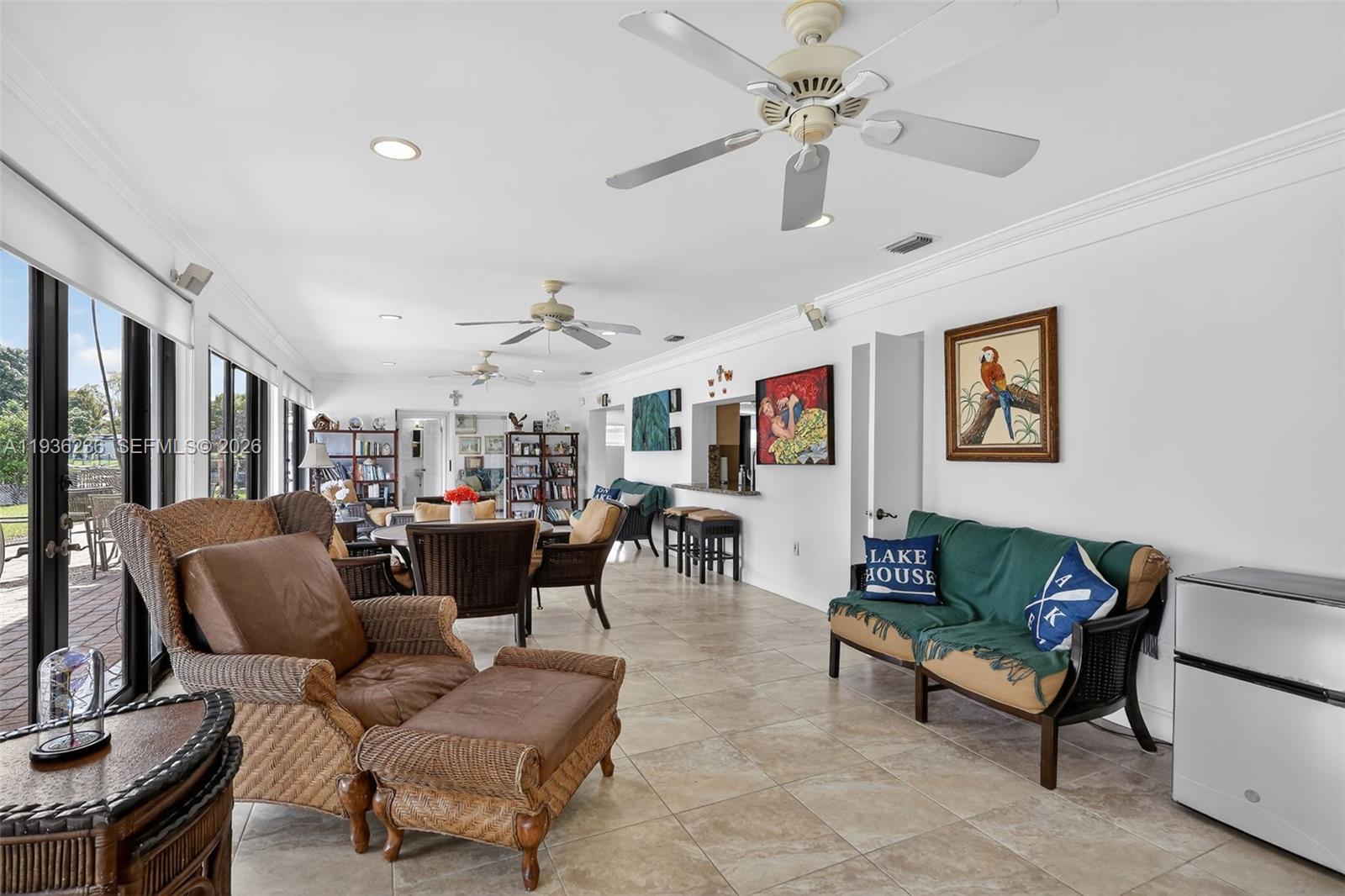 17841 Northwest 84th Court Hialeah, FL 33015 - Photo 24 of 76 a living room with furniture a ceiling fan and a rug