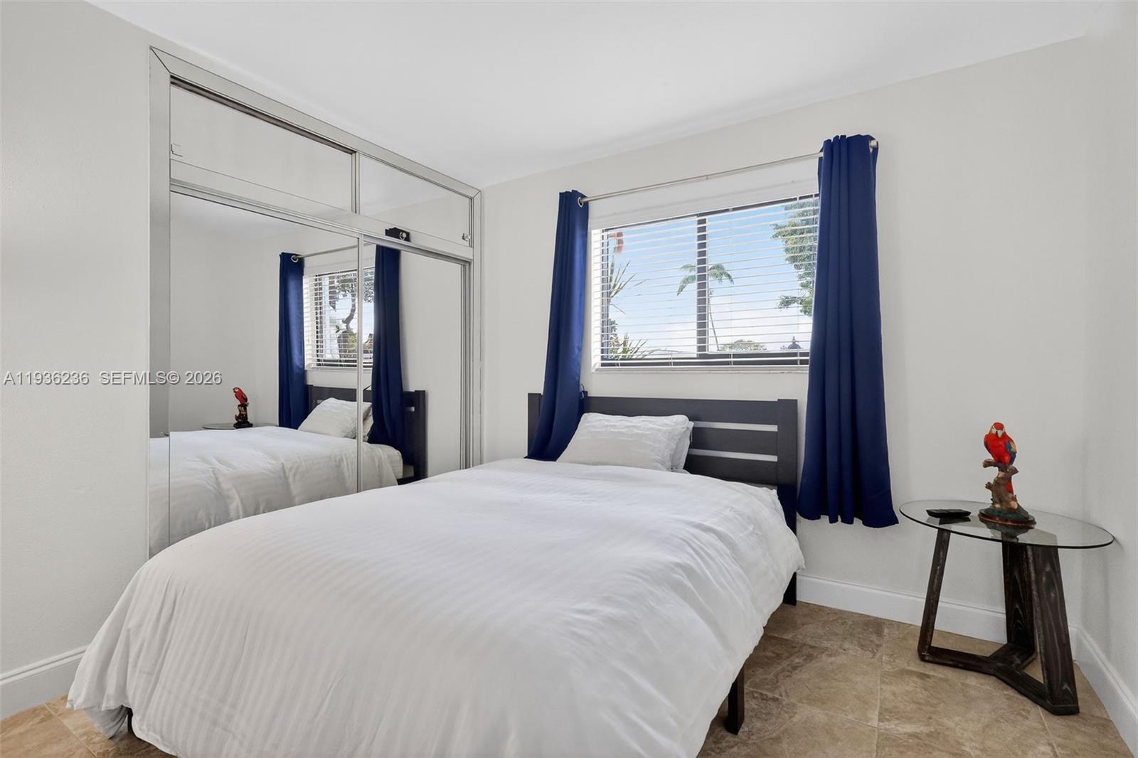 17841 Northwest 84th Court Hialeah, FL 33015 - Photo 30 of 76 a bedroom with a bed and a painting on the wall