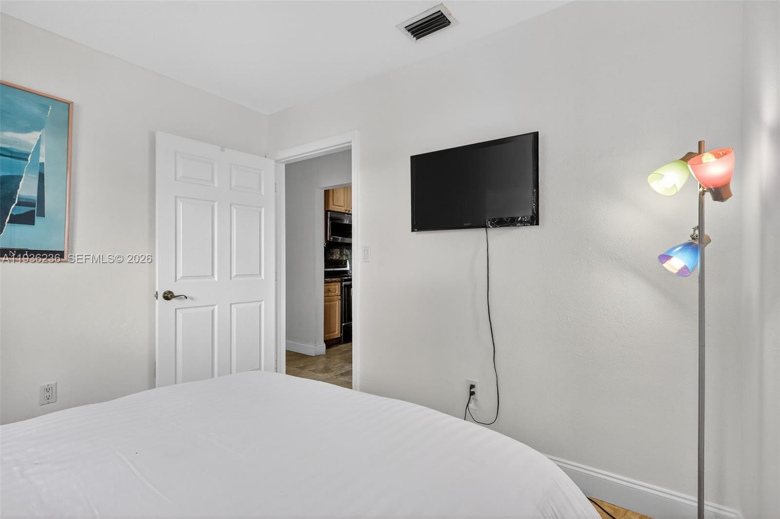 17841 Northwest 84th Court Hialeah, FL 33015 - Photo 31 of 76 a bedroom with a bed and a flat screen tv