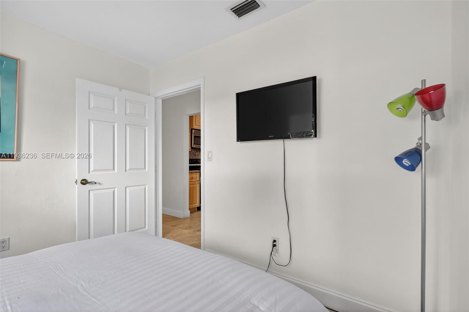 17841 Northwest 84th Court Hialeah, FL 33015 - Photo 32 of 76 a bedroom with a bed and a flat screen tv