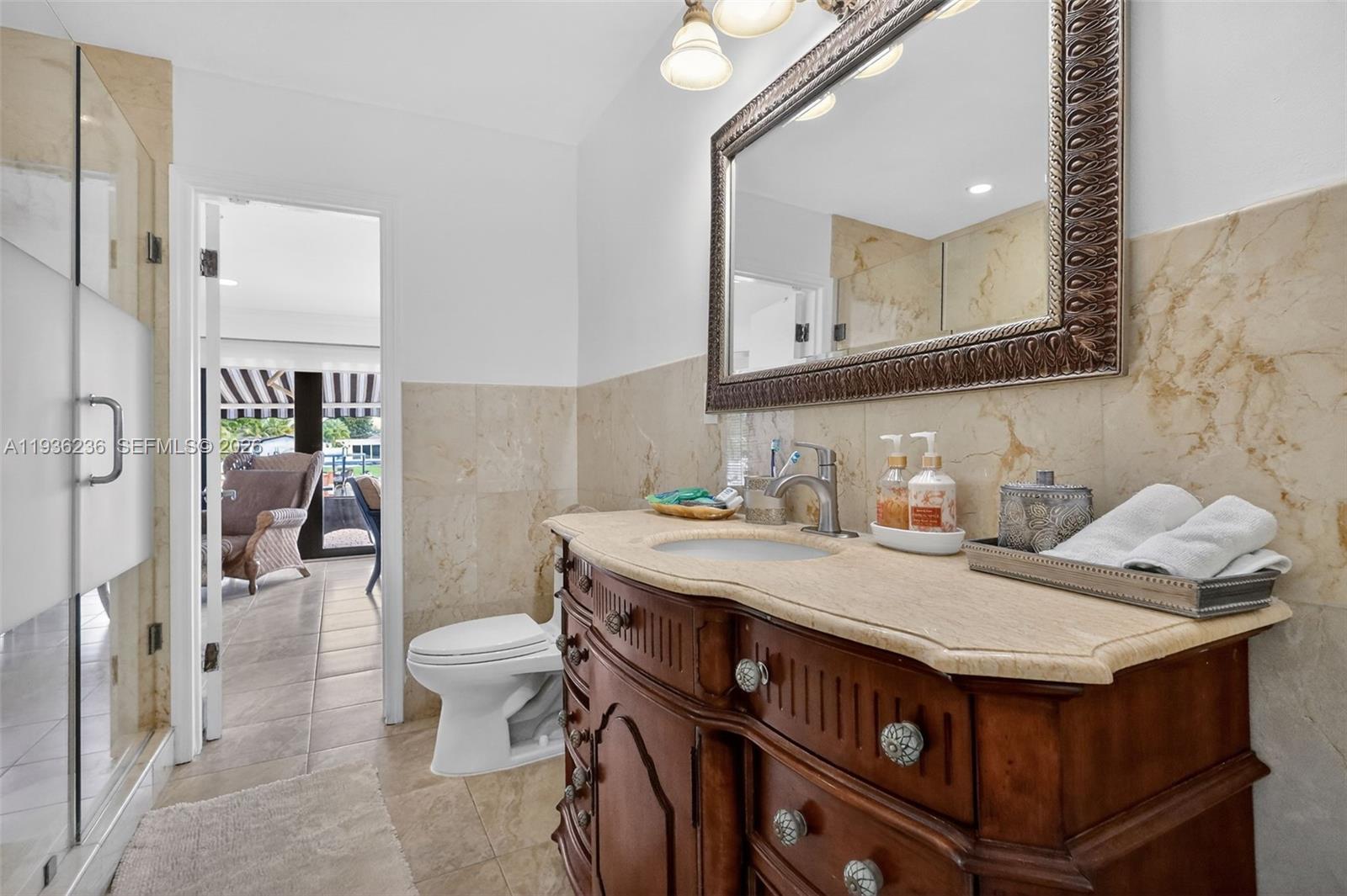 17841 Northwest 84th Court Hialeah, FL 33015 - Photo 37 of 76 a bathroom with a sink a toilet and mirror