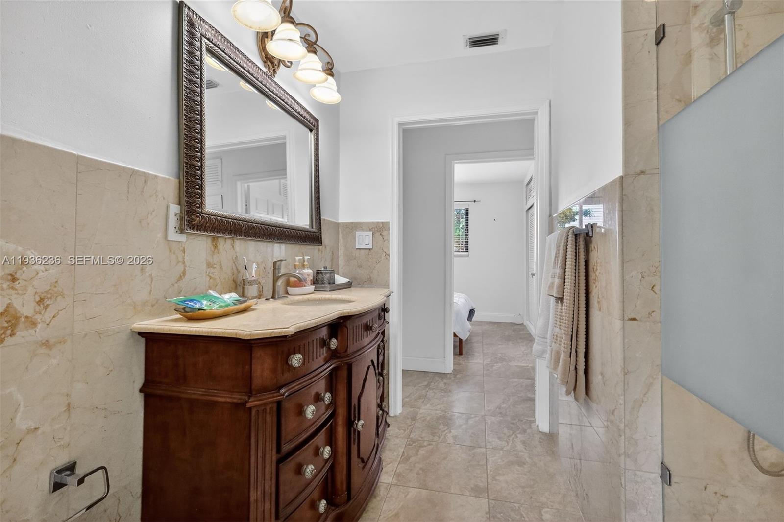 17841 Northwest 84th Court Hialeah, FL 33015 - Photo 38 of 76 a bathroom with a sink a mirror and a toilet