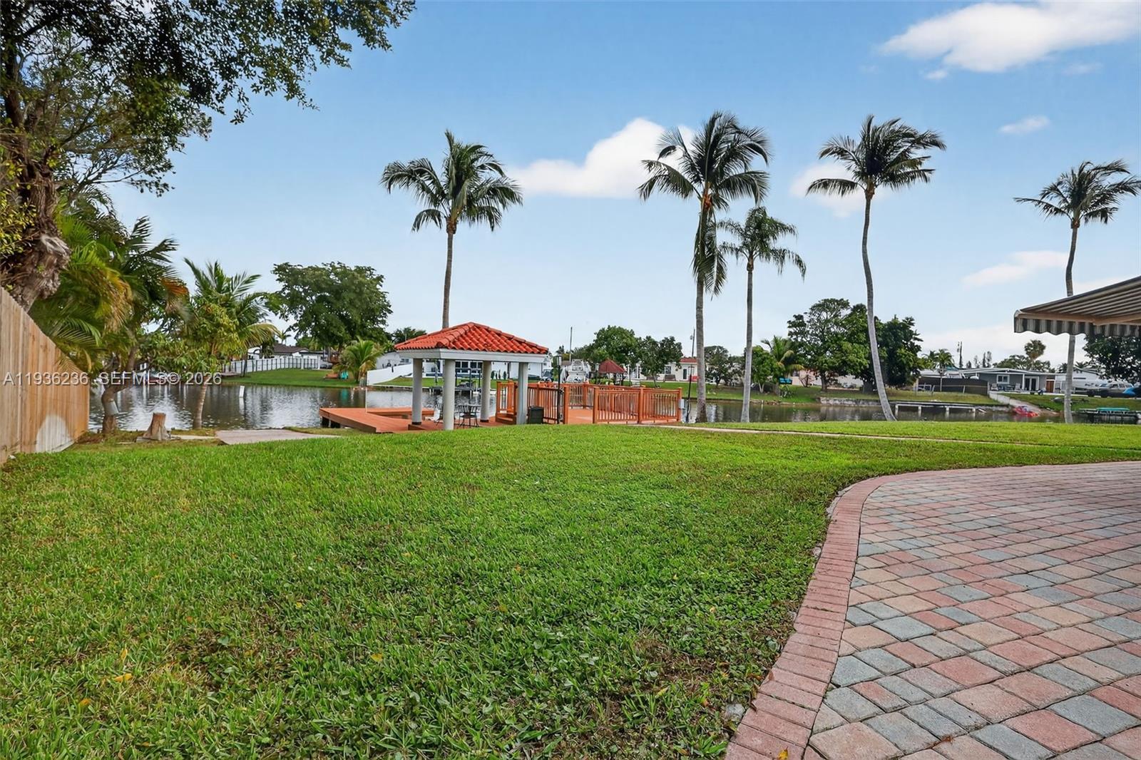 17841 Northwest 84th Court Hialeah, FL 33015 - Photo 44 of 76 a view of a park with a table and chairs potted plants and palm trees