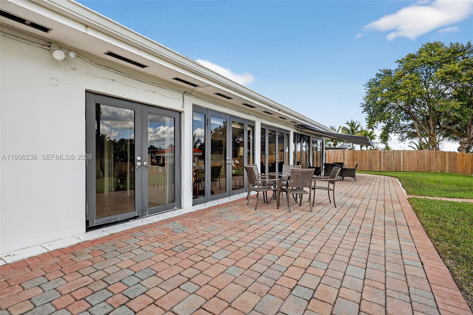 17841 Northwest 84th Court Hialeah, FL 33015 - Photo 47 of 76 a view of a patio with table and chairs and a barbeque