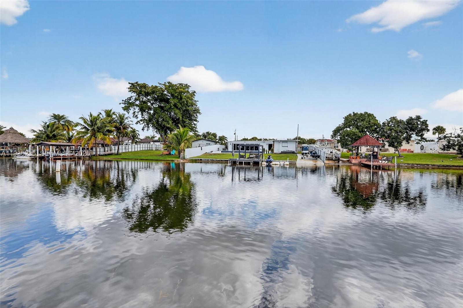 17841 Northwest 84th Court Hialeah, FL 33015 - Photo 61 of 76 a view of a lake with boats and trees in the background