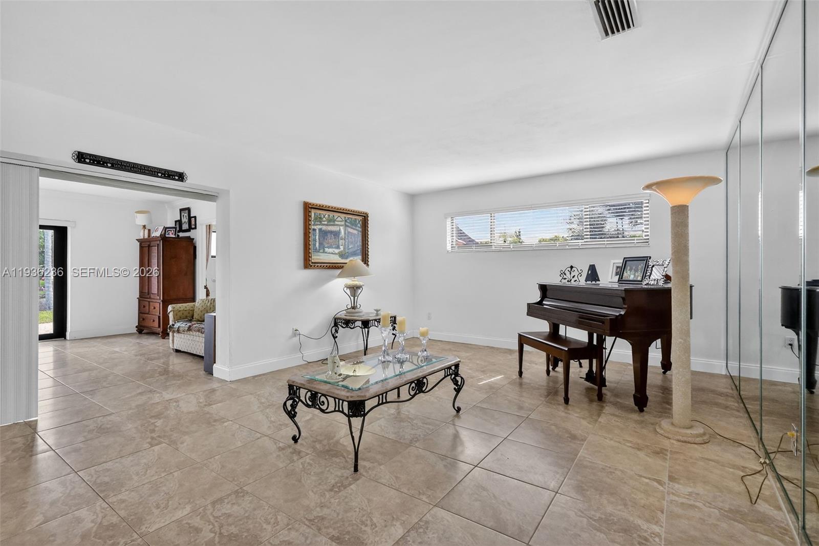 17841 Northwest 84th Court Hialeah, FL 33015 - Photo 7 of 76 a living room with furniture and a table
