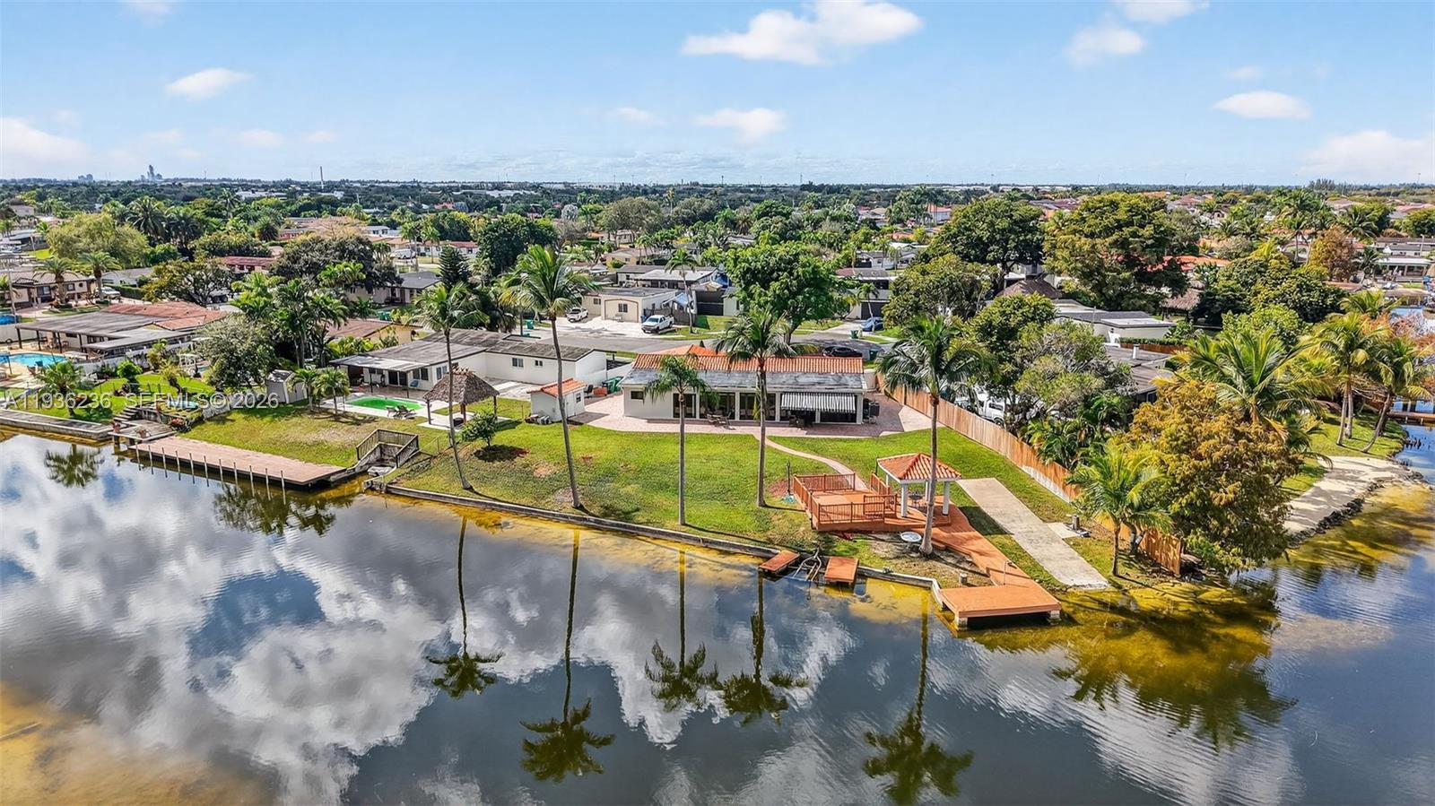 17841 Northwest 84th Court Hialeah, FL 33015 - Photo 75 of 76 an aerial view of a swimming pool patio and lake view