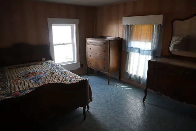 a bedroom with a bed and a window