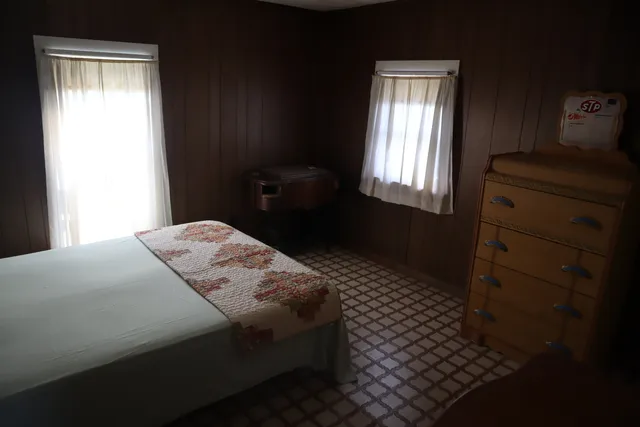 a bedroom with a bed and a window