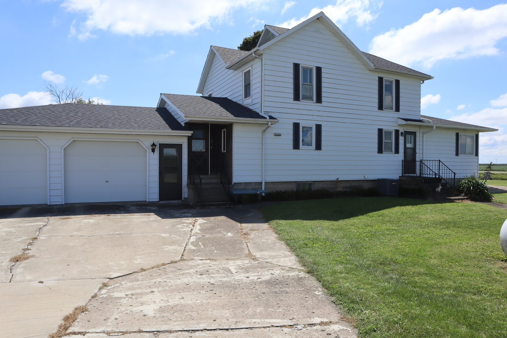132 Indian Head Road Walnut, IL 61376 - Photo 2 of 20 a front view of a house with a yard and garage