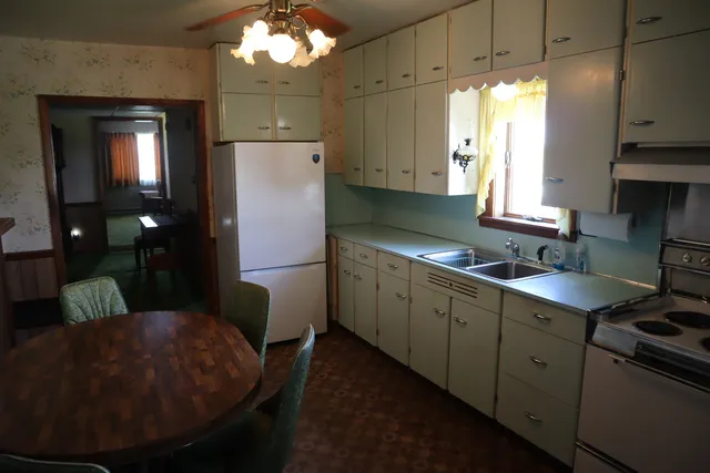 a kitchen with a sink cabinets and window