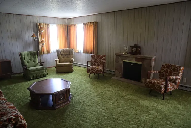 a living room with furniture and a fireplace