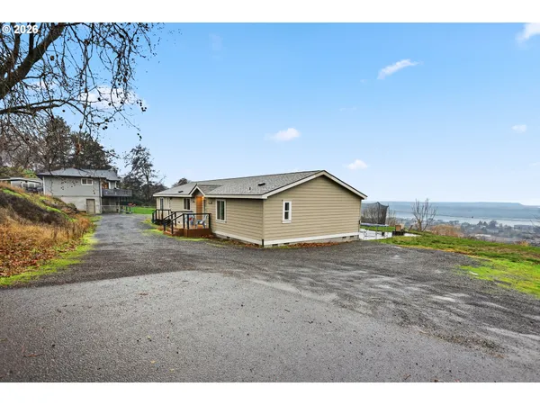 a view of a house with a yard and a garage