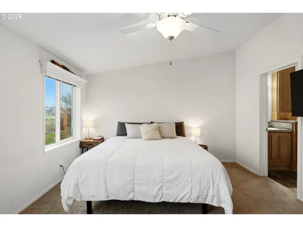a bedroom with a large bed and a chandelier