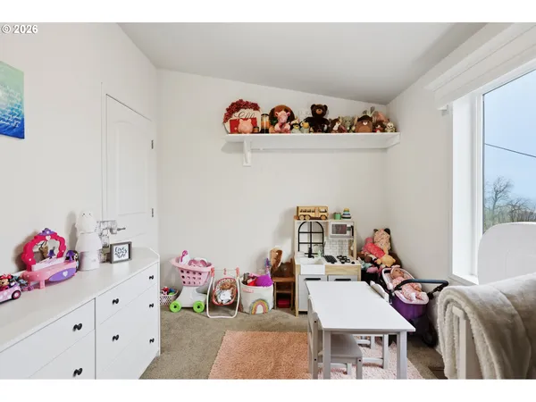 a bedroom with baby bed toys and a baby crib