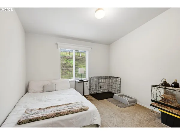 a bedroom with a bed and a tv