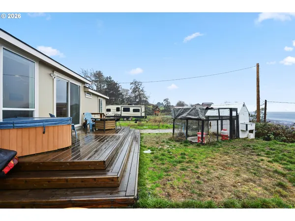 a view of a house with pool and chairs