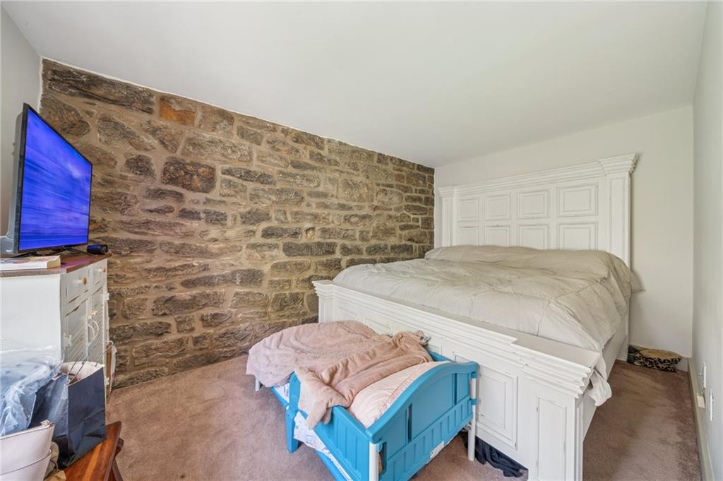 107 Hatfield Street Jefferson, PA 15344 - Photo 29 of 35 a bedroom with a bed and a fireplace