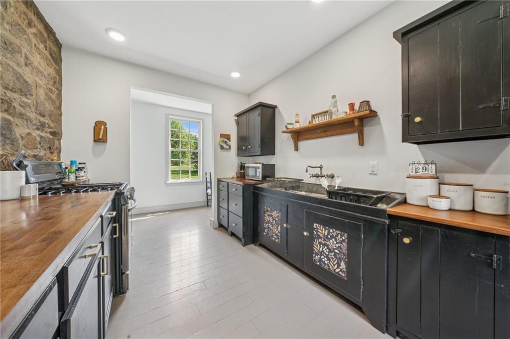 107 Hatfield Street Jefferson, PA 15344 - Photo 8 of 35 a kitchen with stainless steel appliances granite countertop a sink stove and refrigerator