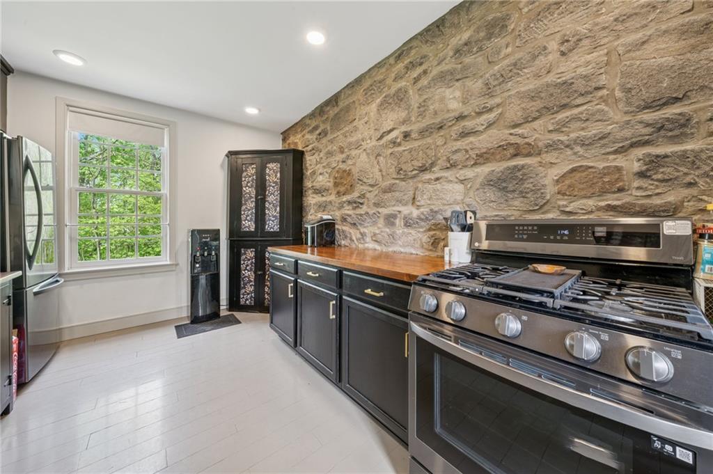 107 Hatfield Street Jefferson, PA 15344 - Photo 9 of 35 a kitchen with stainless steel appliances a stove and a refrigerator