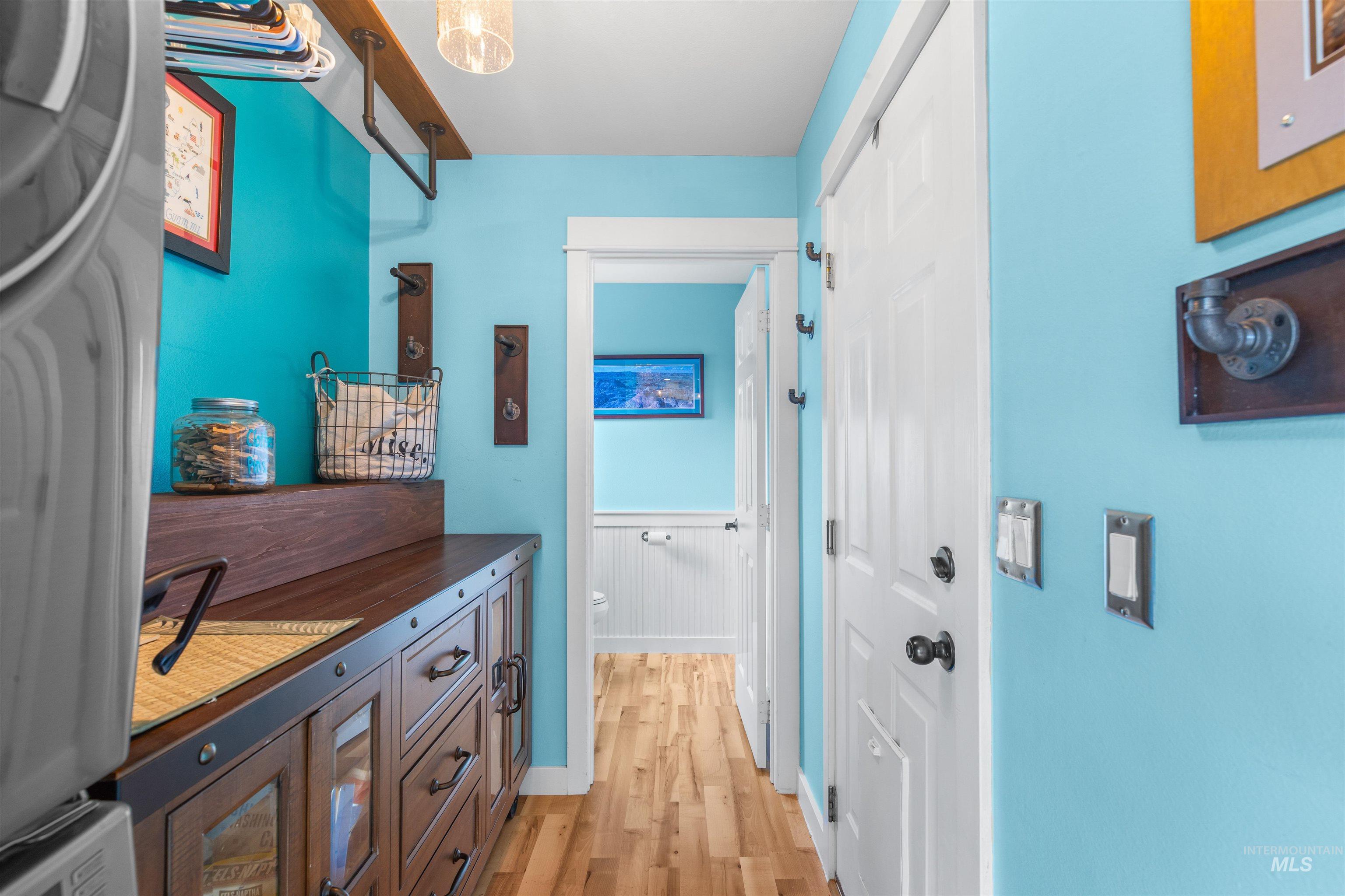 2435 Arborcrest Road Moscow, ID 83843 - Photo 26 of 50 Hall with light wood finished floors, stacked washing machine and dryer, and wainscoting